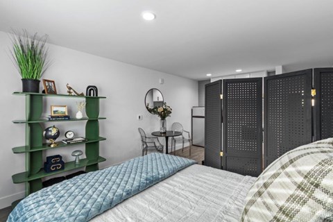 a bedroom with a bed and a table with a chair